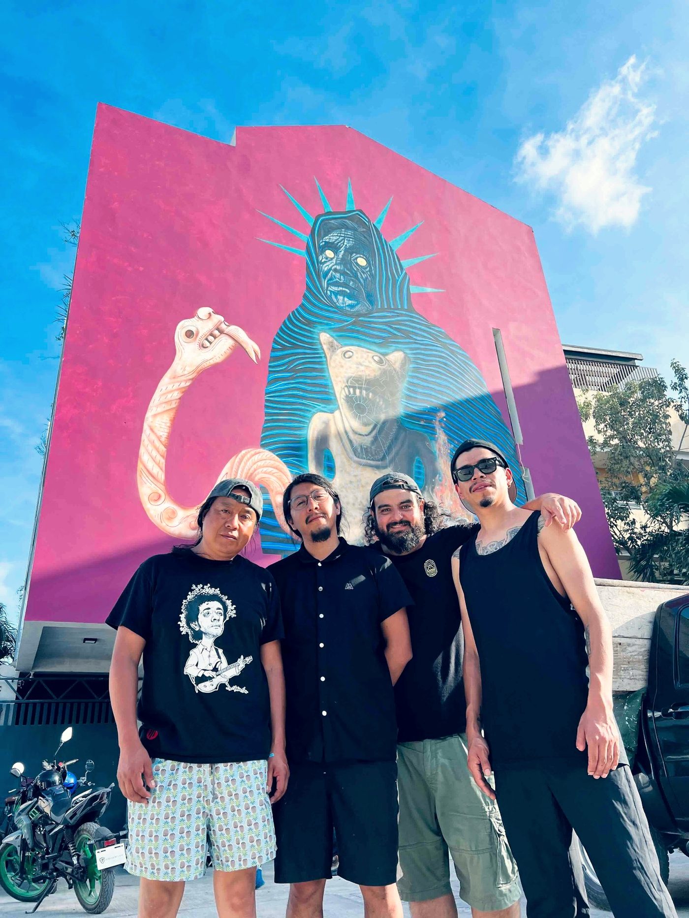 Artists in front of large mural, Tulum